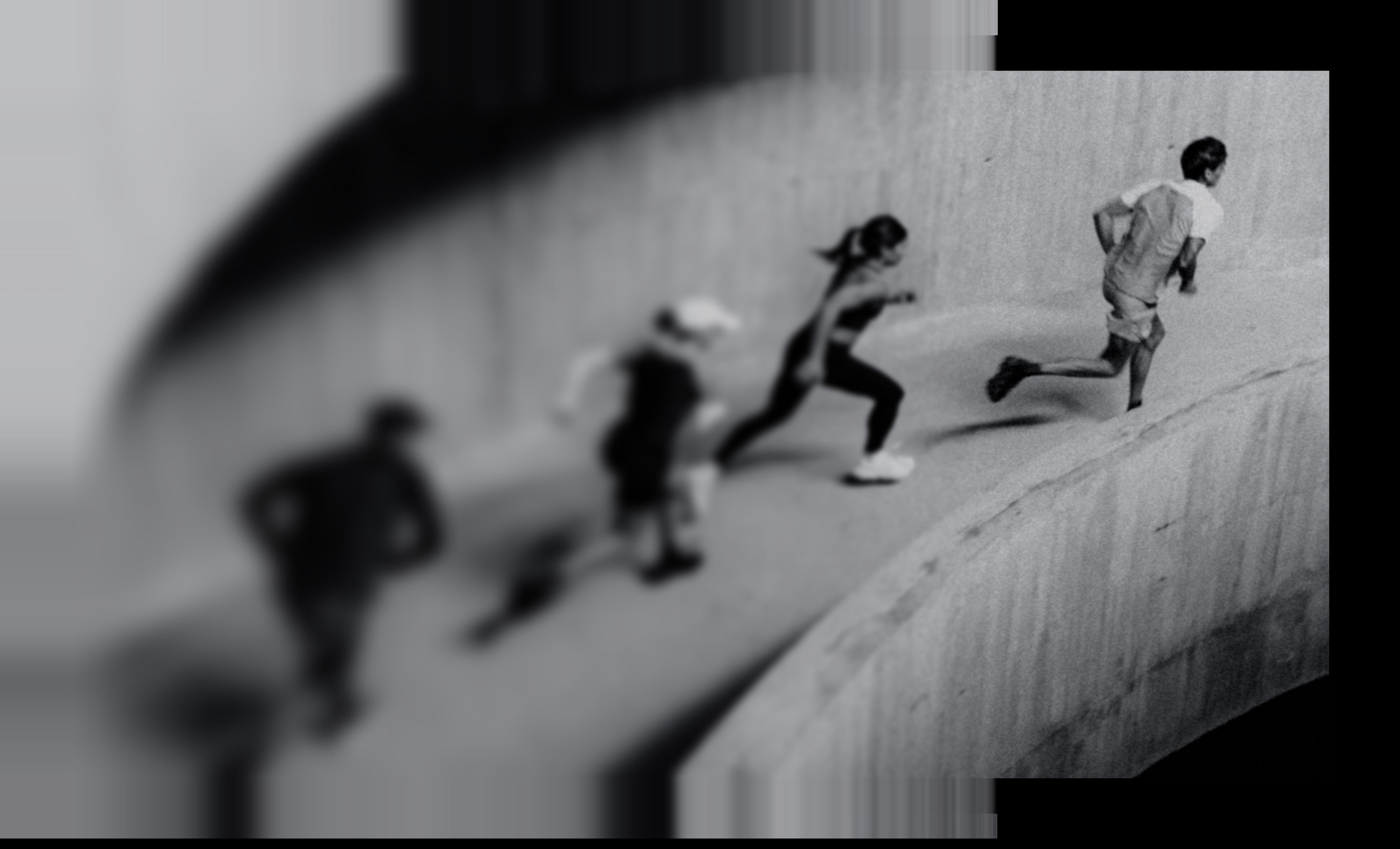 Runners ascending a curved concrete ramp